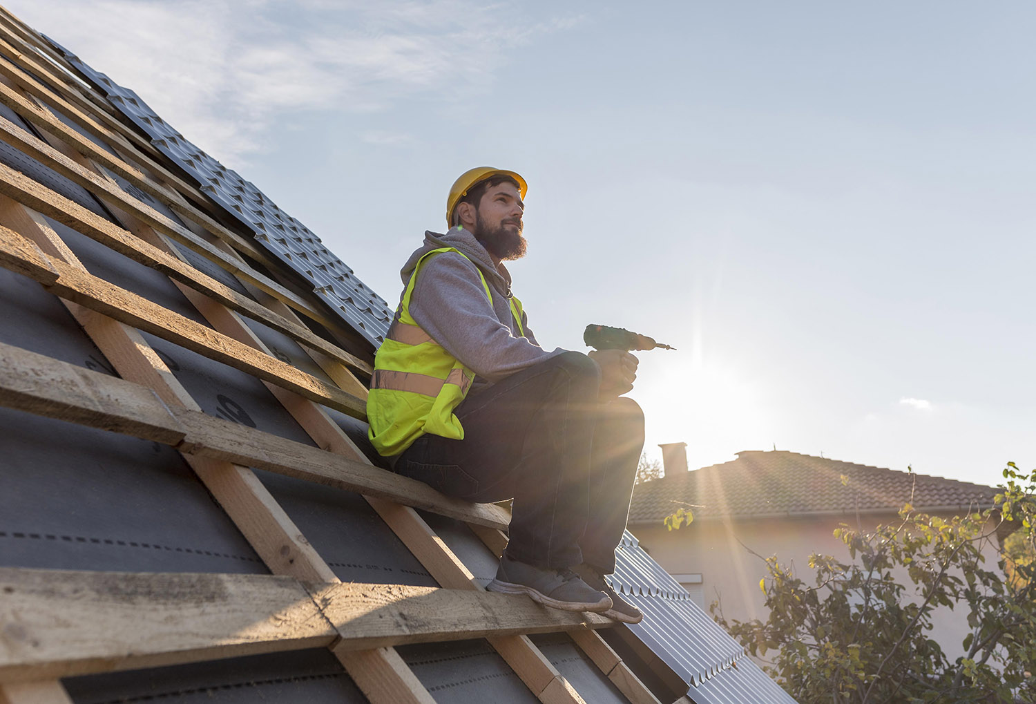 working sitting on new construction roofing working sitting on new construction roofing